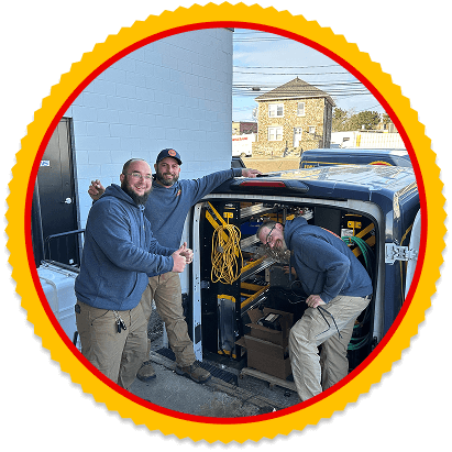 Yellow Dog technicians standing by an open service van